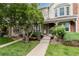 Charming home featuring a well-maintained front yard with lush landscaping, a cozy bench, and a welcoming entrance at 9620 W Chatfield Ave # D, Littleton, CO 80128