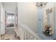 Hallway featuring neutral paint colors, chandelier, and decorative wall mirror and decorations at 9620 W Chatfield Ave # D, Littleton, CO 80128