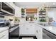 Bright kitchen featuring stainless steel appliances, white marble countertops, and modern fixtures at 9620 W Chatfield Ave # D, Littleton, CO 80128