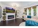 Stylish living room featuring a modern fireplace, plush seating, and elegant decor accents under a unique light fixture at 9620 W Chatfield Ave # D, Littleton, CO 80128