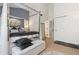 Bedroom featuring neutral carpet, canopy bed, white closet doors and ensuite at 9620 W Chatfield Ave # D, Littleton, CO 80128
