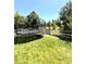 Spacious backyard with lush lawn, mature trees, a trampoline, and a white picket fence at 2896 Gemini Loop, Broomfield, CO 80023