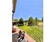 Well-maintained backyard featuring a patio, lawn, and distant view of a lush green golf course at 2896 Gemini Loop, Broomfield, CO 80023