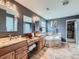 Elegant bathroom showcasing double vanities, a soaking tub, granite counters, and a spacious walk-in closet at 2896 Gemini Loop, Broomfield, CO 80023