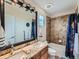 Bathroom featuring double sinks, granite counters, and a separate shower and tub at 2896 Gemini Loop, Broomfield, CO 80023
