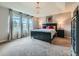 Spacious bedroom featuring a chandelier, three windows, and modern furnishings for a relaxing retreat at 2896 Gemini Loop, Broomfield, CO 80023