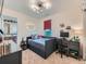 Cozy bedroom with a sleek daybed, modern desk, and an adjacent bathroom at 2896 Gemini Loop, Broomfield, CO 80023