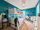 Vibrant ' bedroom with a bunk bed, bright blue walls, and a playful atmosphere at 2896 Gemini Loop, Broomfield, CO 80023