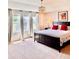 Bright bedroom with large windows, light-colored walls, and a dark wood bed frame at 2896 Gemini Loop, Broomfield, CO 80023