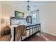Cozy bedroom with a black metal bed frame, a decorative lamp, and a window, a relaxing retreat at 2896 Gemini Loop, Broomfield, CO 80023