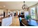 Open dining area with hardwood floors, contemporary chandelier, and natural light at 2896 Gemini Loop, Broomfield, CO 80023