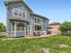 Back exterior of a blue two-story home with a patio and outdoor dining set for entertaining at 2896 Gemini Loop, Broomfield, CO 80023