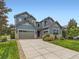 Beautiful two-story home featuring a manicured lawn, stone accents, and a spacious driveway leading to a two-car garage at 2896 Gemini Loop, Broomfield, CO 80023