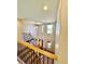 Second floor hallway with iron and wood railing with a view down to the front door at 2896 Gemini Loop, Broomfield, CO 80023