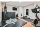 Spacious home gym with padded floors, a wall-mounted TV, and exercise equipment at 2896 Gemini Loop, Broomfield, CO 80023