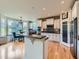Well-appointed kitchen with an island, white cabinetry, granite countertops, stainless steel appliances, and breakfast nook at 2896 Gemini Loop, Broomfield, CO 80023
