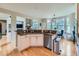 Modern kitchen featuring granite countertops, stainless steel appliances, and an adjacent breakfast nook with scenic views at 2896 Gemini Loop, Broomfield, CO 80023