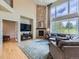 Bright and open living room with a soaring fireplace, large windows, and comfortable seating, creating a welcoming atmosphere at 2896 Gemini Loop, Broomfield, CO 80023