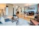 Spacious living room with hardwood floors connecting seamlessly to the dining area, ideal for entertaining and relaxing at 2896 Gemini Loop, Broomfield, CO 80023