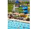 Community pool with a water slide, lounge chairs, and umbrellas for residents to enjoy the summer at 2896 Gemini Loop, Broomfield, CO 80023
