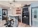 Stylish wet bar featuring a brick-front counter, seating, and a dark wood bar cabinet at 2896 Gemini Loop, Broomfield, CO 80023