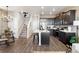 Open kitchen blends seamlessly with dining, showcasing modern design, an island, and ample storage at 1364 S Boston Ct # A, Denver, CO 80247