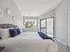 Comfortable bedroom featuring large window and sliding glass door to balcony at 5690 W 80Th Pl # 101, Arvada, CO 80003