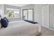 Bright bedroom featuring large window, sliding door, and light gray walls at 5690 W 80Th Pl # 101, Arvada, CO 80003