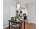 Dining room that opens into the kitchen with modern light fixture at 5690 W 80Th Pl # 101, Arvada, CO 80003