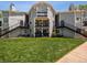 Multi-level apartment building with stairs and balconies, surrounded by green lawn at 5690 W 80Th Pl # 101, Arvada, CO 80003