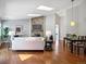 Open-concept living room featuring wood floors, stone fireplace, and skylights at 5690 W 80Th Pl # 101, Arvada, CO 80003