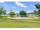 Community playground area with lake views featuring play structures, swings and a basketball court at 5690 W 80Th Pl # 101, Arvada, CO 80003