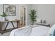 Inviting bedroom shows access to bath, soft colors and modern decor at 1919 Eaton St, Lakewood, CO 80214