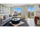 Stylish living room with contemporary decor, large windows, and comfortable gray couch and view at 1919 Eaton St, Lakewood, CO 80214