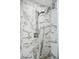 Close-up of stylish shower with marble-look tile and a handheld shower head at 1919 Eaton St, Lakewood, CO 80214