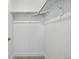A walk-in closet is simply designed with white walls, base trim and a single shelf with a hanging bar at 1919 Eaton St, Lakewood, CO 80214