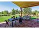 Covered patio featuring an outdoor dining set, comfortable seating, and beautiful landscaping at 1294 Kittery St, Castle Rock, CO 80104