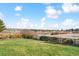 Expansive backyard with green lawn, bordered by a wooden fence with trees in the background at 1294 Kittery St, Castle Rock, CO 80104