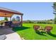 Expansive backyard with lush lawn, mature trees, outdoor seating, and covered area perfect for entertaining at 1294 Kittery St, Castle Rock, CO 80104