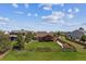 Aerial view of a large backyard with a patio, seating, lush lawn, and scenic surroundings at 1294 Kittery St, Castle Rock, CO 80104