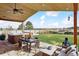 Covered patio and backyard with outdoor seating, fireplace, hot tub and a beautiful view at 1294 Kittery St, Castle Rock, CO 80104