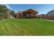 Large backyard showcasing a covered patio, outdoor seating, green grass, and beautiful landscaping at 1294 Kittery St, Castle Rock, CO 80104