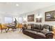 Basement lounge area with comfortable seating, pictures, and neutral colored carpet at 1294 Kittery St, Castle Rock, CO 80104