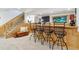 Basement bar with dark metal barstools, a nearby staircase, and adjacent seating area at 1294 Kittery St, Castle Rock, CO 80104