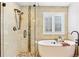 Bathroom boasts a separate shower, soaking tub, and neutral tile at 1294 Kittery St, Castle Rock, CO 80104