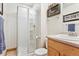 Bathroom featuring a shower and an oak vanity with countertop sink and modern fixtures at 1294 Kittery St, Castle Rock, CO 80104