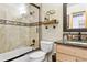 Bright bathroom features a shower-tub combo and neutral tiling at 1294 Kittery St, Castle Rock, CO 80104
