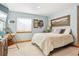 Bright bedroom with desk, large window, and a mountain painting above the bed at 1294 Kittery St, Castle Rock, CO 80104