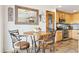 Eat-in kitchen features a cozy breakfast nook, wood-look floors, and a decorative mirror at 1294 Kittery St, Castle Rock, CO 80104
