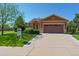 Charming single-story home with a well-manicured lawn, featuring a two-car garage and inviting curb appeal at 1294 Kittery St, Castle Rock, CO 80104